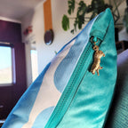 By John Designs white and blue African giraffe pattern scatter cushion with velvet and gold leopard pendent